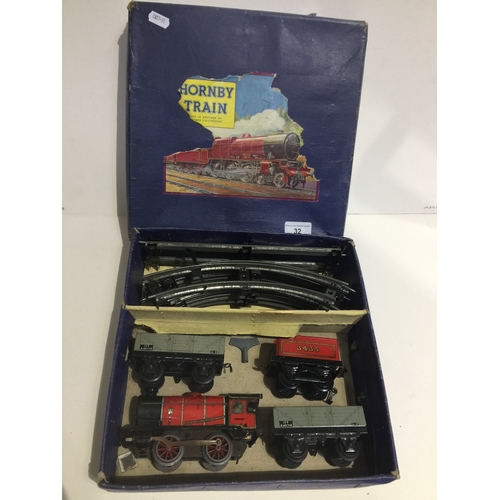 32 - A Hornby 0 gauge clockwork goods train and 2 open waggons set with key
