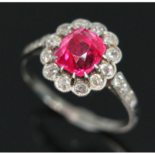 102 - An antique pink spinel and diamond cluster ring, the central vivid pink rectangular cushion cut ston...