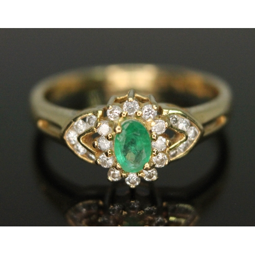 110 - A hallmarked 18ct gold diamond and emerald cluster ring, the cluster measuring approx. 13.05mm x 8.5... 