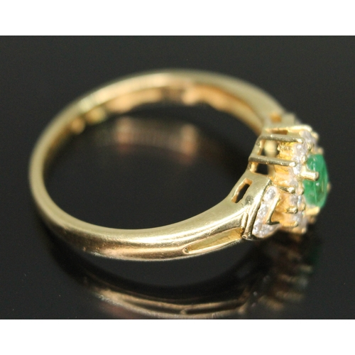 110 - A hallmarked 18ct gold diamond and emerald cluster ring, the cluster measuring approx. 13.05mm x 8.5... 