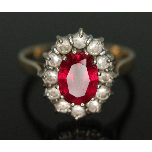 123 - A synthetic ruby and cubic zirconia cluster ring, band marked '585', gross wt. 2.95g, size M.