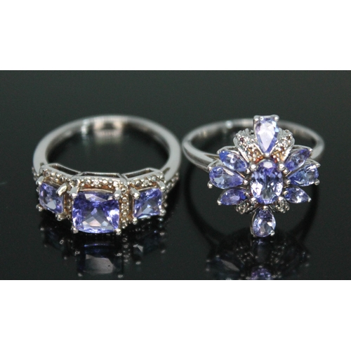 132 - Two hallmarked 9ct white gold tanzanite and diamond cluster rings, gross wt. 5.33g, size O.