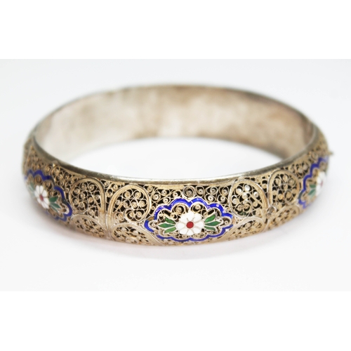 157 - A white and gilt metal filigree bangle with enamel decoration, indistinctly marked, diam. approx. 58... 