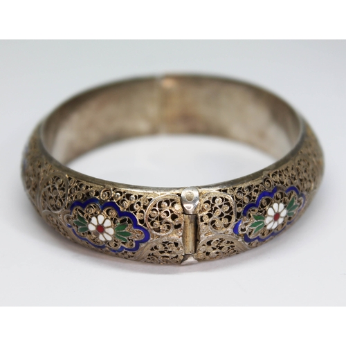 157 - A white and gilt metal filigree bangle with enamel decoration, indistinctly marked, diam. approx. 58... 