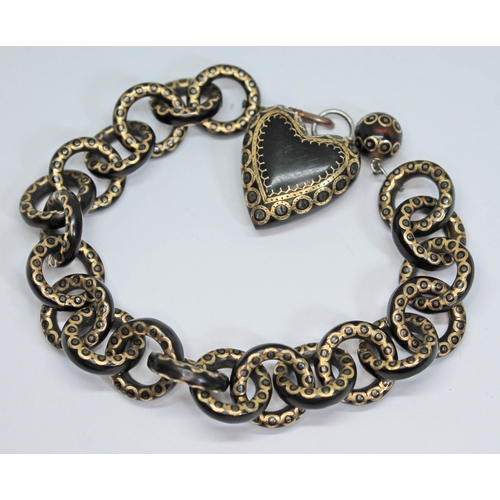 158 - A Victorian pique inlaid tortoiseshell bracelet with heart shaped drop, length 20cm.