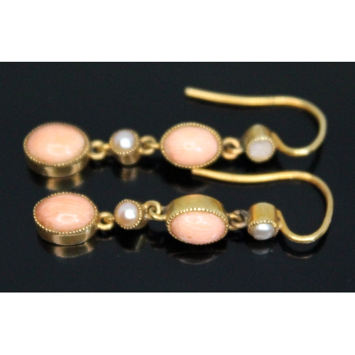 160 - A pair of early 20th century millegrain set coral cabochon and split pearl drop earrings, marked '15... 