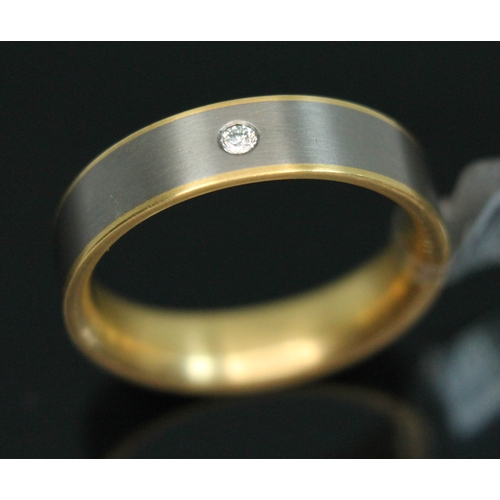 67 - A yellow metal and titanium wedding band by Feniom, inverted D-section, the outer edge set with a di... 