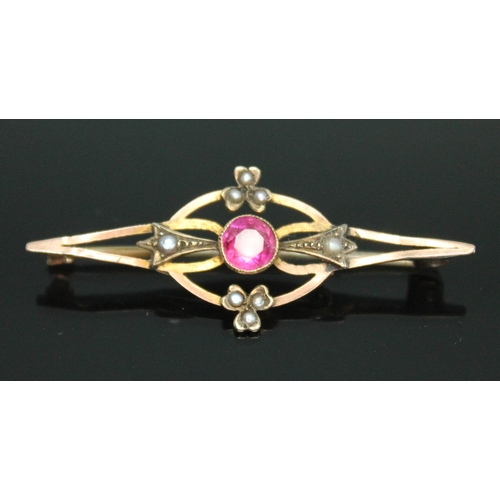 82 - An early 20th century pink sapphire and split pearl brooch, length 45mm, marked '9ct', gross wt. 2.3... 