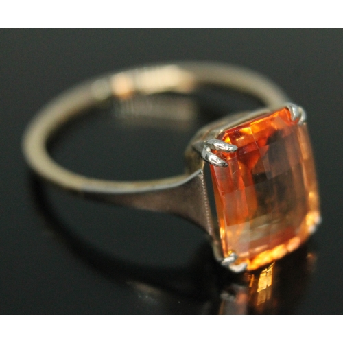 86 - A fancy orange synthetic sapphire ring, the briollete cushion cut stone weighing approx. 4.01 carats... 