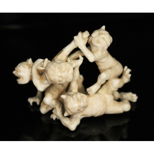 330 - A Japanese Meji period carved ivory okimono depicting four fighting goblins, two character signature... 