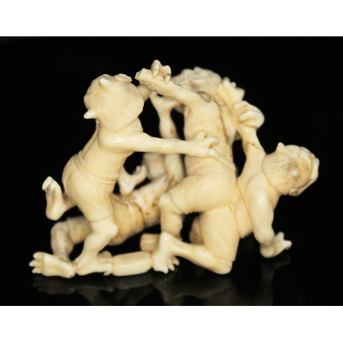 330 - A Japanese Meji period carved ivory okimono depicting four fighting goblins, two character signature... 