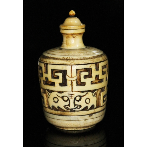 333 - A Chinese ivory snuff bottle, of barrel form and carved with archaic designs, height 83mm.