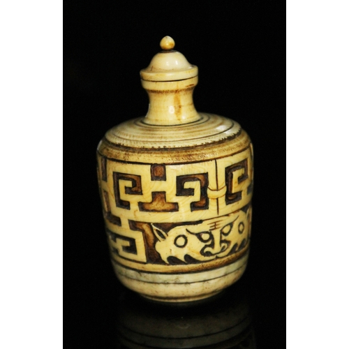 333 - A Chinese ivory snuff bottle, of barrel form and carved with archaic designs, height 83mm.