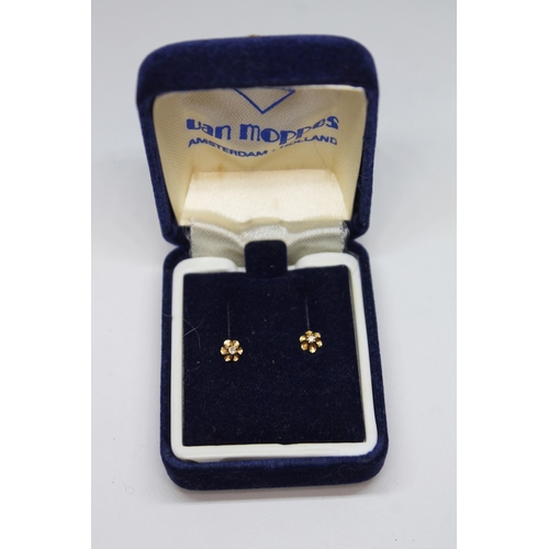 469 - A pair of diamond stud earrings marked '14k'.