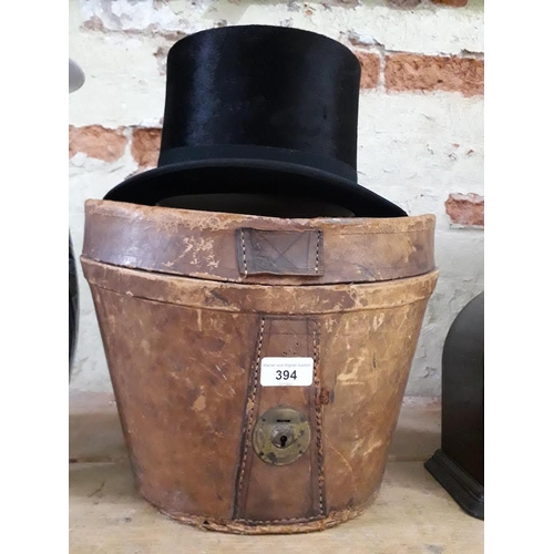 394 - An old top hat with leather hat box.