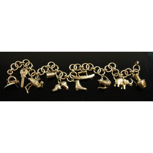 129 - A hallmarked 9ct gold charm bracelet, the bracelet formed from Cartier C-Logo style links, each link... 