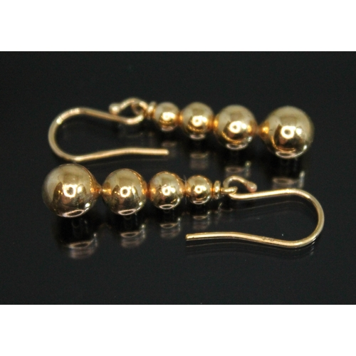 145 - A pair of drop earrings formed as stacked graduated spheres, marked '9ct', length 37mm (including lo... 