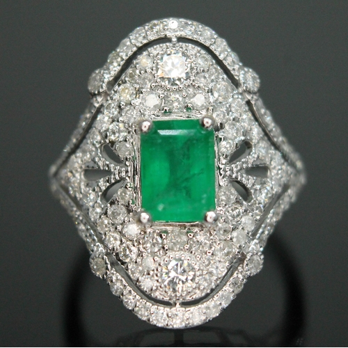 147 - An emerald and diamond ring, the central emerald cut stone weighing approx. 1.04ct, surround by 107 ... 