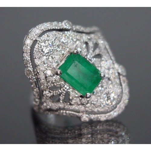 147 - An emerald and diamond ring, the central emerald cut stone weighing approx. 1.04ct, surround by 107 ... 