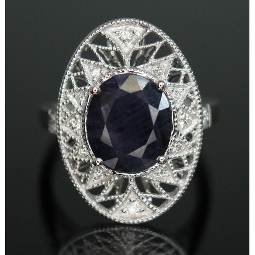 148 - A fancy purple sapphire and diamond cluster ring, the oval cut central stone weighing approx. 3.45ct... 