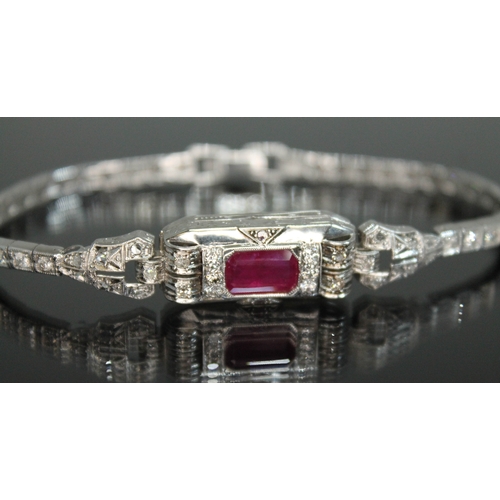 150 - An Art Deco style diamond and ruby bracelet, the emerald cut ruby weighing approx. 4.50 carats, tota... 