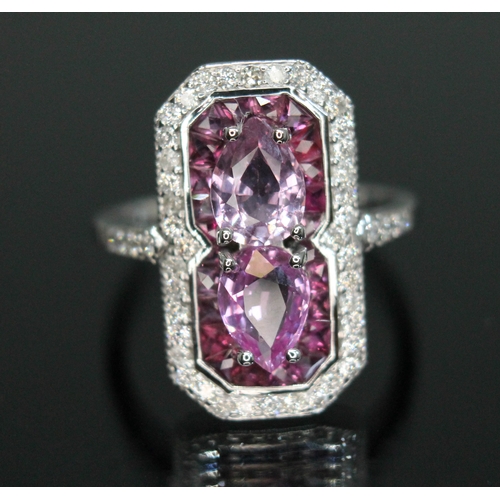 154 - A sapphire, diamond and ruby cluster ring, halo design with two pear cut pink sapphires weighing app... 