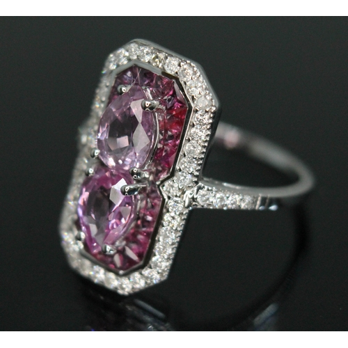 154 - A sapphire, diamond and ruby cluster ring, halo design with two pear cut pink sapphires weighing app... 