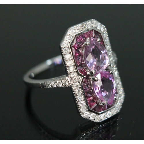 154 - A sapphire, diamond and ruby cluster ring, halo design with two pear cut pink sapphires weighing app... 