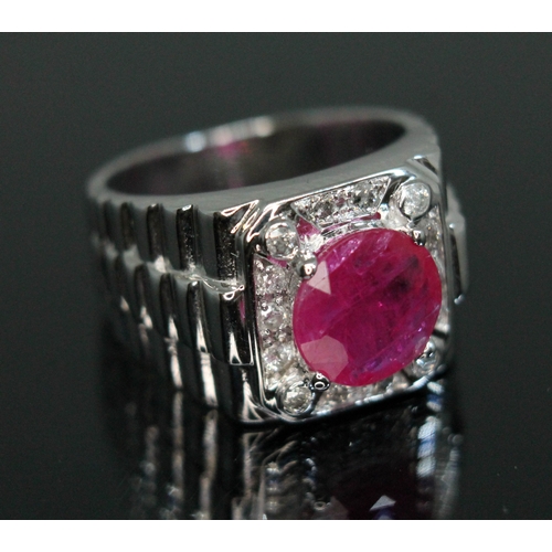 155 - A ruby and diamond signet ring, the central round stone weighing approx. 1.68 carats, measuring appr... 