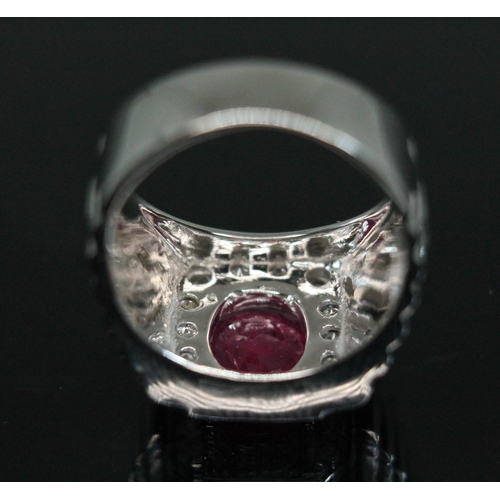 155 - A ruby and diamond signet ring, the central round stone weighing approx. 1.68 carats, measuring appr... 