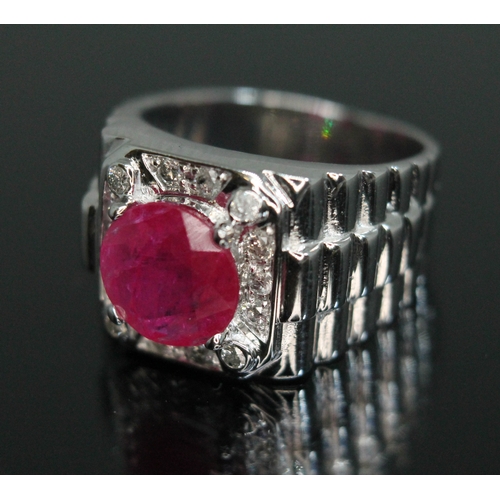 155 - A ruby and diamond signet ring, the central round stone weighing approx. 1.68 carats, measuring appr... 