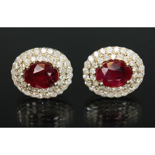 156 - A pair of ruby and diamond cluster earrings, each cluster measuring approx. 14mm x 12mm, each marked... 