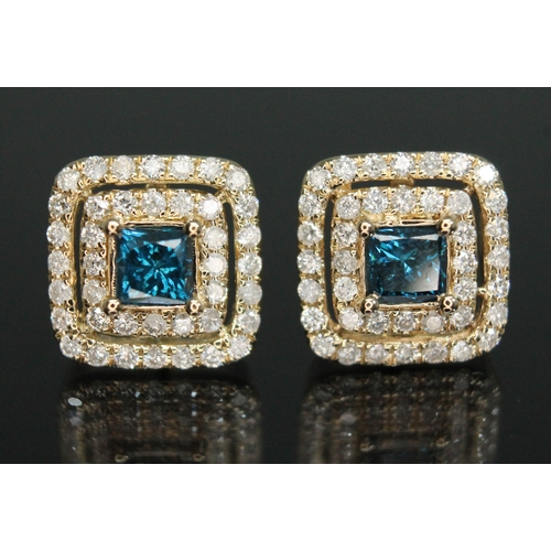 157 - A pair of diamond cluster earrings, each set with a princess cut blue diamond and surround by two ro... 