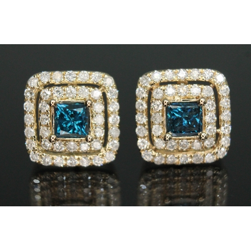 157 - A pair of diamond cluster earrings, each set with a princess cut blue diamond and surround by two ro... 