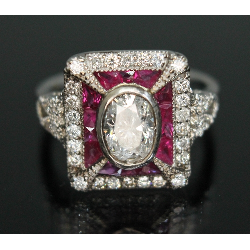 158 - A diamond and ruby cluster ring, the central bezel set oval cut diamond weighing approx. 1 carat, su... 