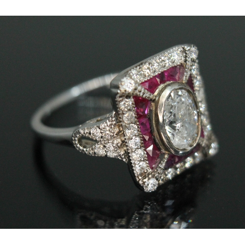 158 - A diamond and ruby cluster ring, the central bezel set oval cut diamond weighing approx. 1 carat, su... 