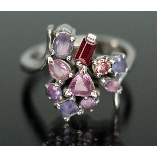 172 - A multi-gem set cluster ring, featuring a pink diamond, a ruby, five pink/purple sapphires and three... 