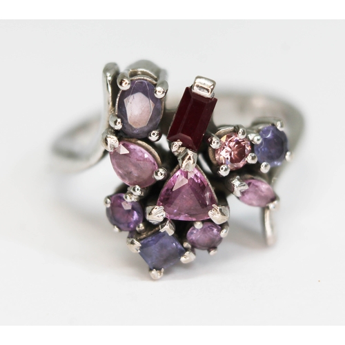 172 - A multi-gem set cluster ring, featuring a pink diamond, a ruby, five pink/purple sapphires and three... 