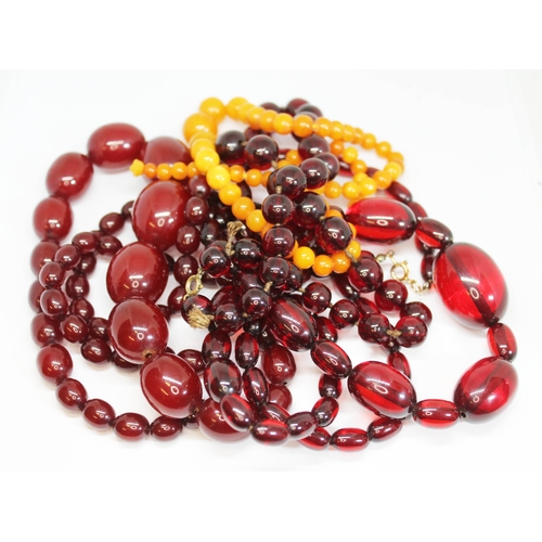 184 - Assorted graduated beads comprising one butterscotch amber and three cherry bakelite necklaces, bead... 