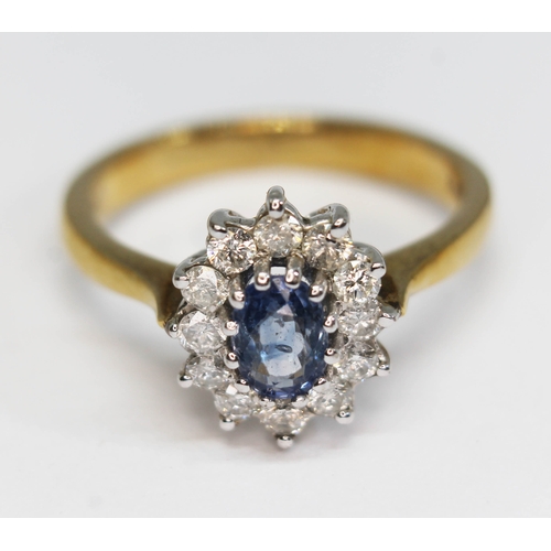 186 - A sapphire and diamond cluster ring, the central oval mixed cut stone weighing approx. 1ct, surround... 