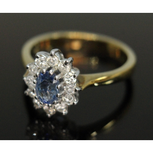 186 - A sapphire and diamond cluster ring, the central oval mixed cut stone weighing approx. 1ct, surround... 