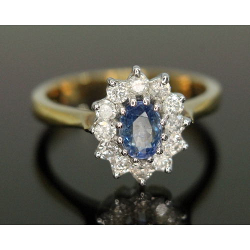 186 - A sapphire and diamond cluster ring, the central oval mixed cut stone weighing approx. 1ct, surround... 