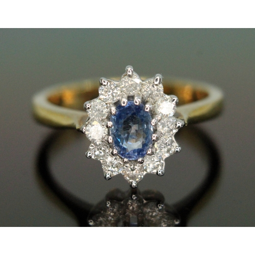 186 - A sapphire and diamond cluster ring, the central oval mixed cut stone weighing approx. 1ct, surround... 