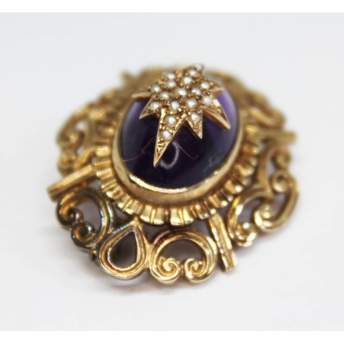 188 - A 9ct gold amethyst and seed pearl brooch, formed as a deep oval amethyst cabochon mounted with a st... 