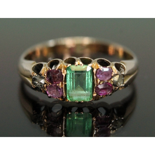 197 - An antique multi-gemstone ring set with Suffragette colours, the central rectangular cut emerald wei... 