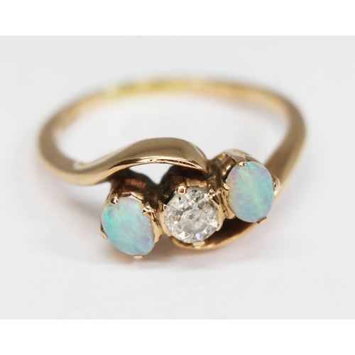 205 - A diamond and opal ring, the central Old European cut diamond weighing approx. 0.22 carats, band ind... 