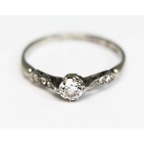 216 - An early 20th century diamond solitaire, the central stone weighing approx. 0.29 carats, diamond set... 