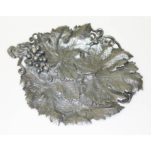 284 - A Victorian silver grape dish, formed as overlapping vine leaves with grape and vine handle, on thre... 