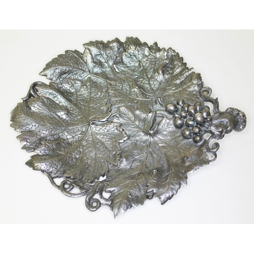 284 - A Victorian silver grape dish, formed as overlapping vine leaves with grape and vine handle, on thre... 