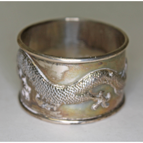 304 - A Chinese Canton silver serviette ring, the outside decorated with a dragon, marked 'SF', probably S... 